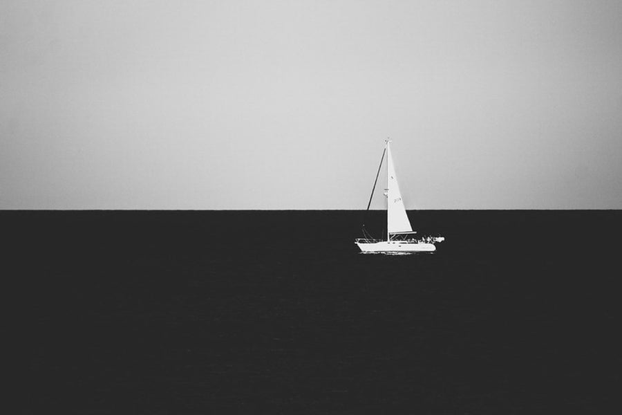 A lone sail, in black and white. Photograph by Robin Mehdee.